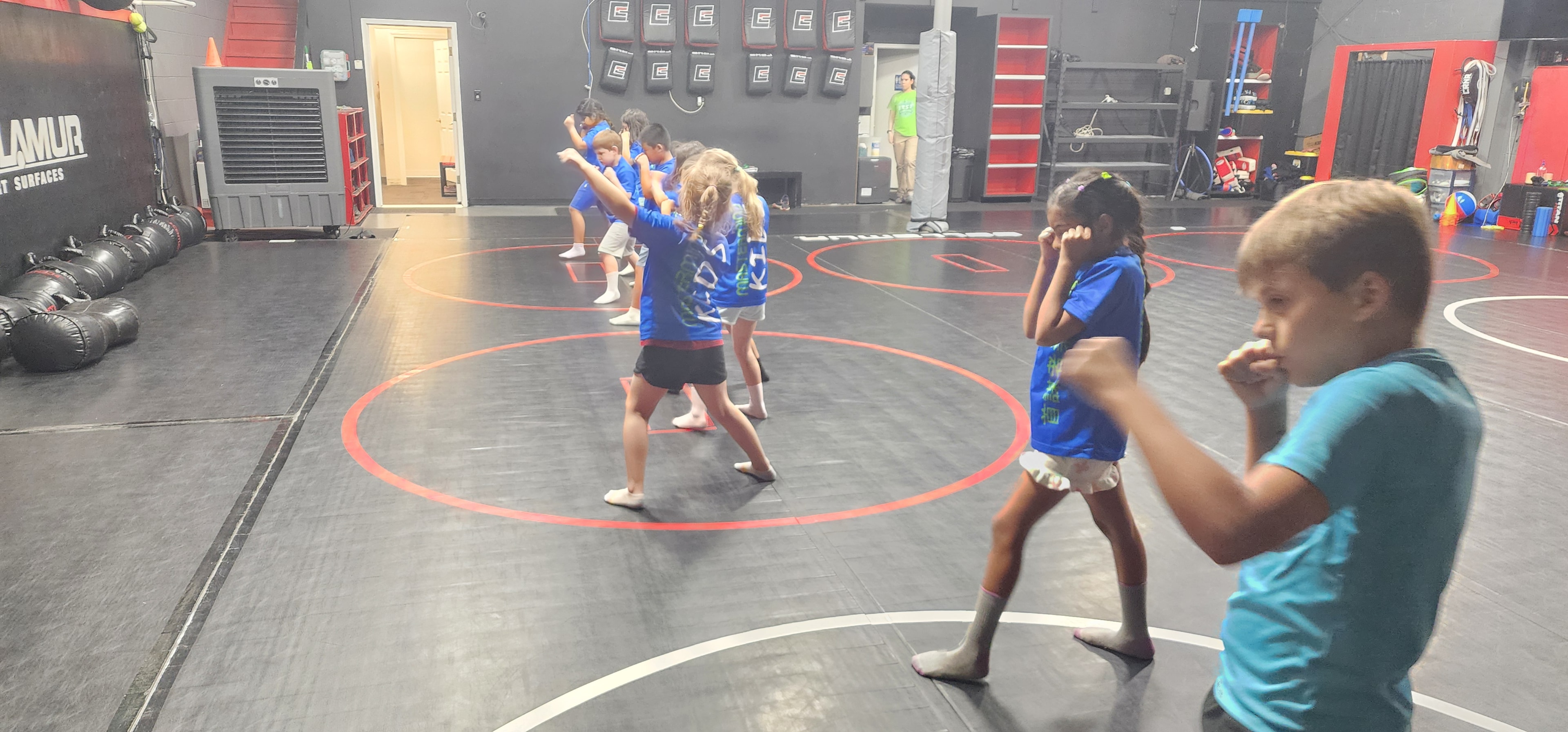 Campers in a self-protection class on the mats