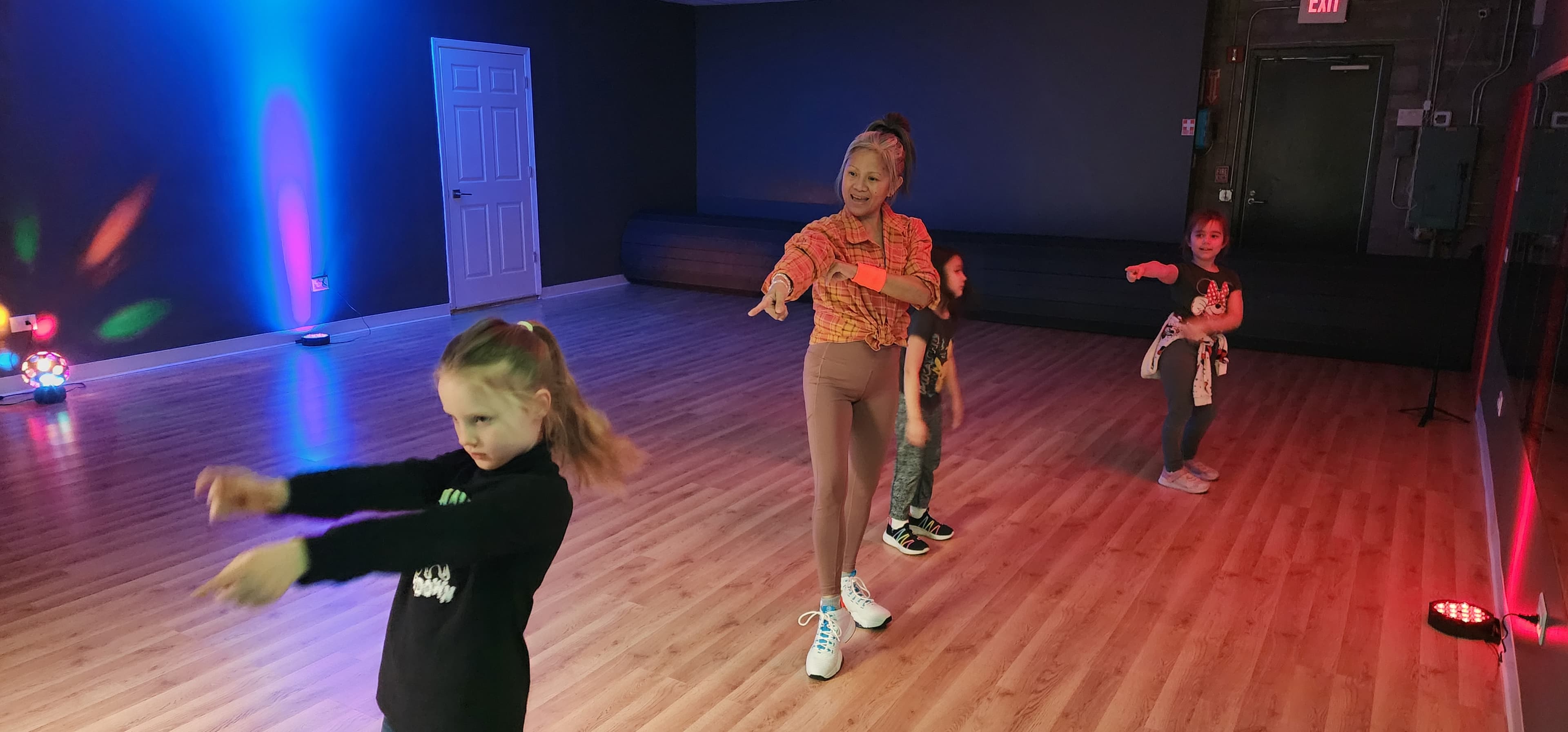 Camper dancing in colorful lighting
