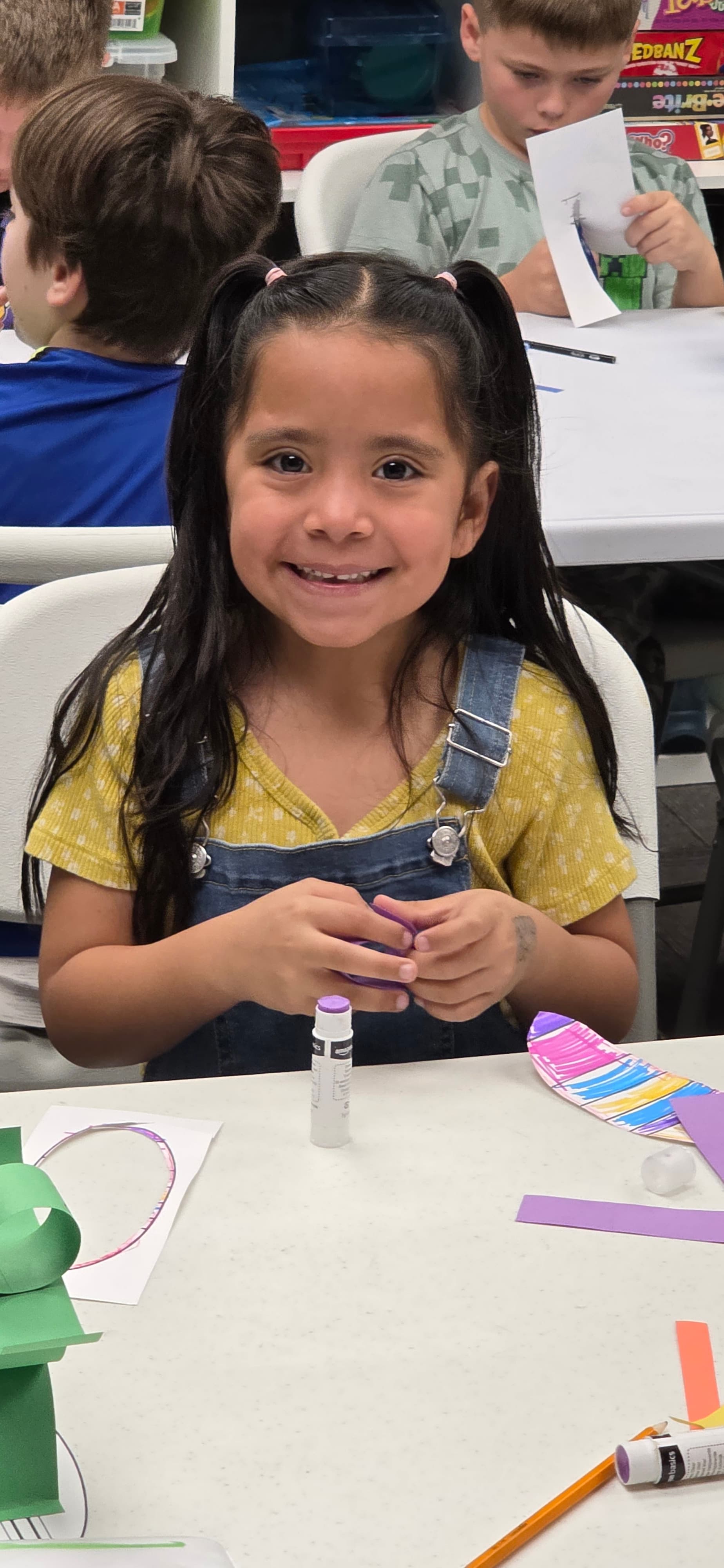 Smiling camper at the craft table