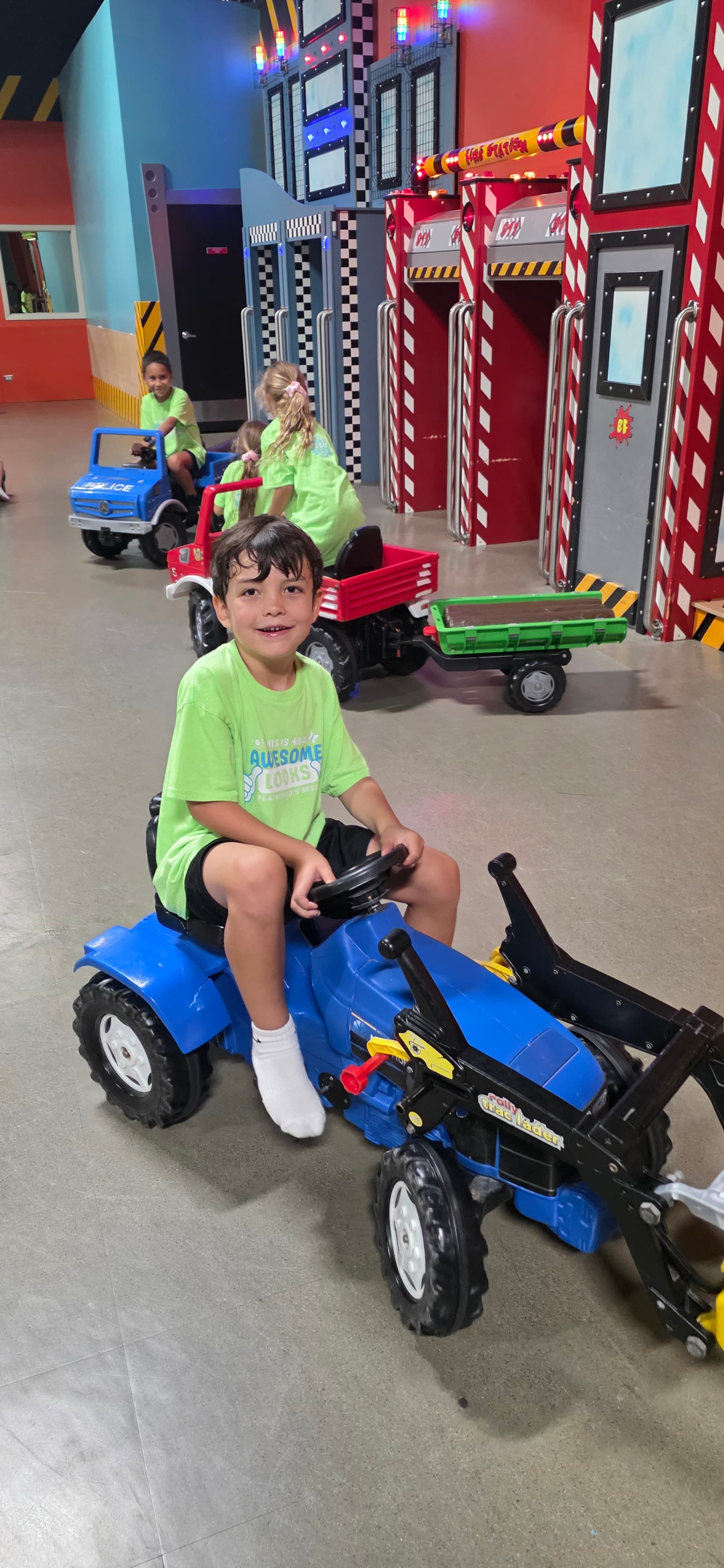 Camper riding a toy tractor