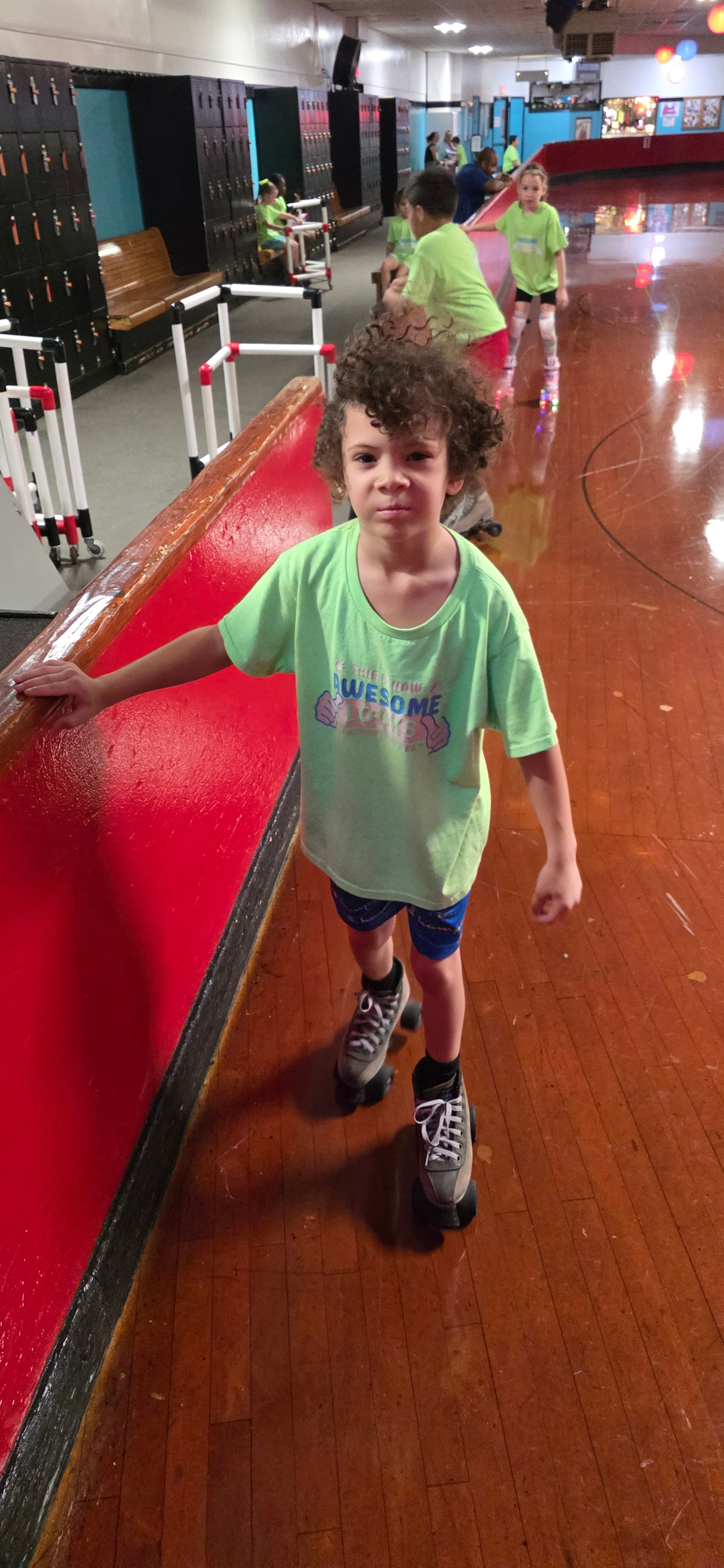 Camper sitting on the floor at a skating outing